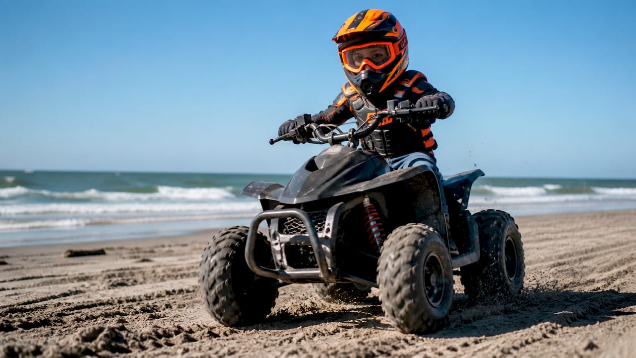 Child safely riding youth ATV outdoors