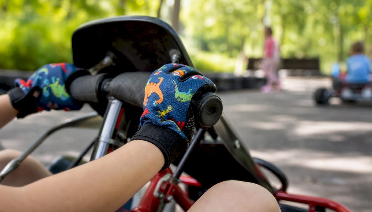Child squeezing throttle wearing gloves