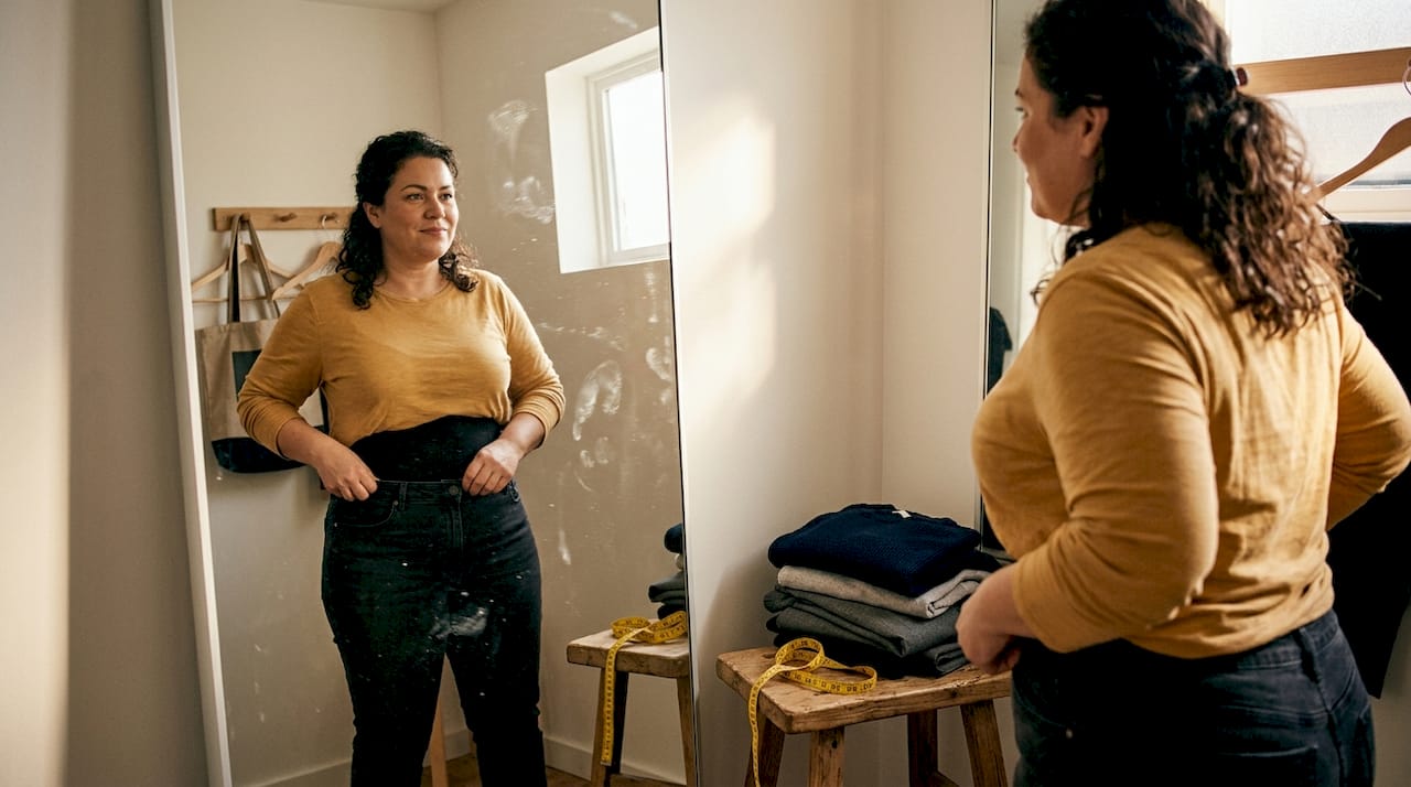 Plus-size woman adjusting shapewear fit