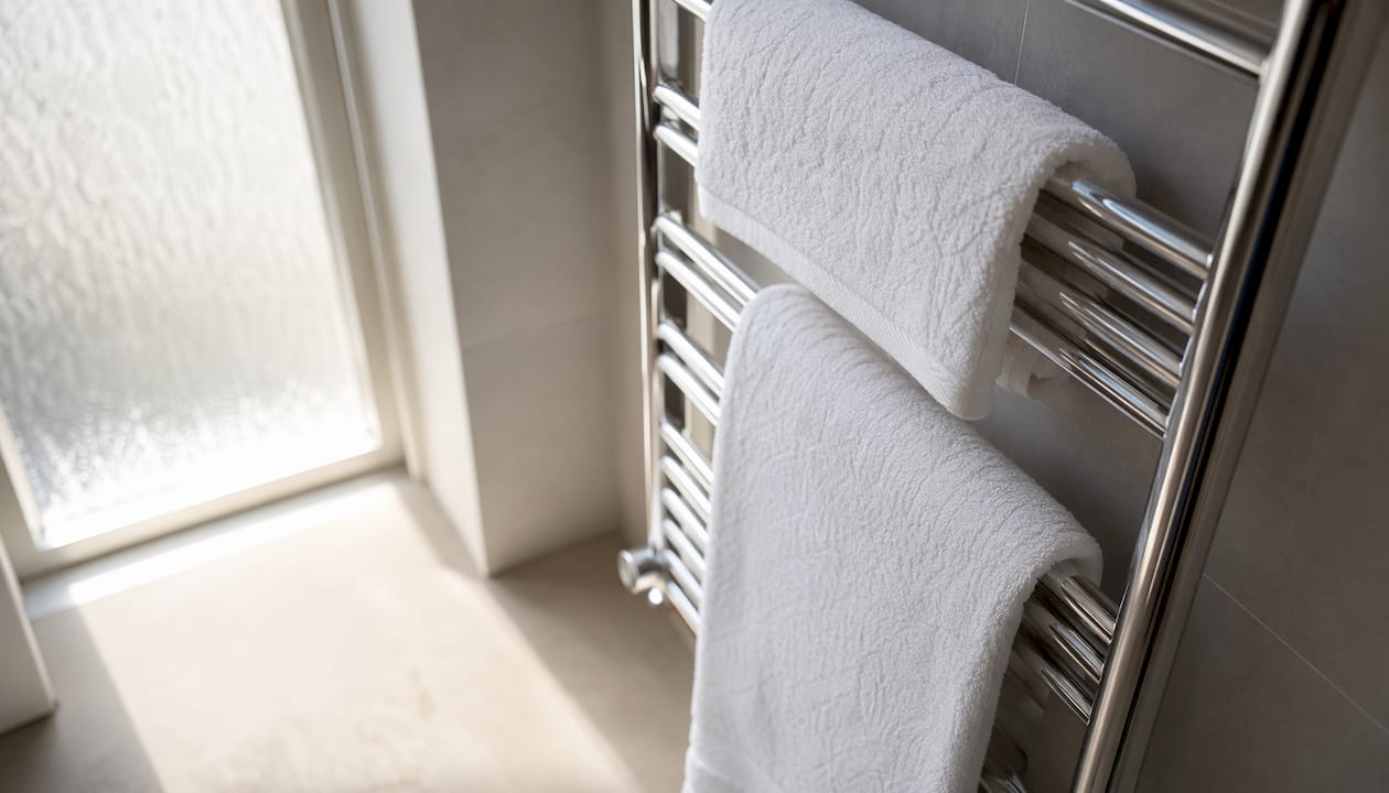Close-up of towels on heated radiator bars