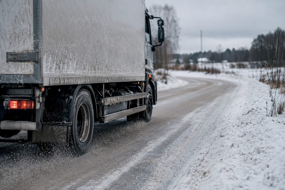 Delivery truck driving on snowy road