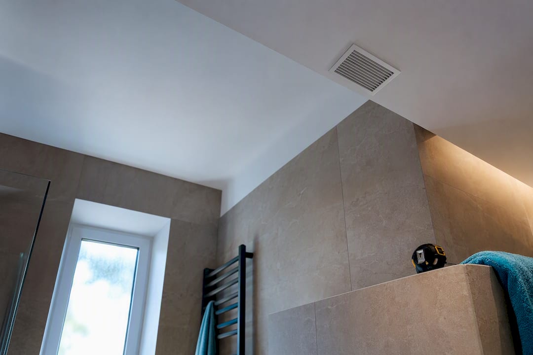 Anonymous bathroom exhaust grille on ceiling