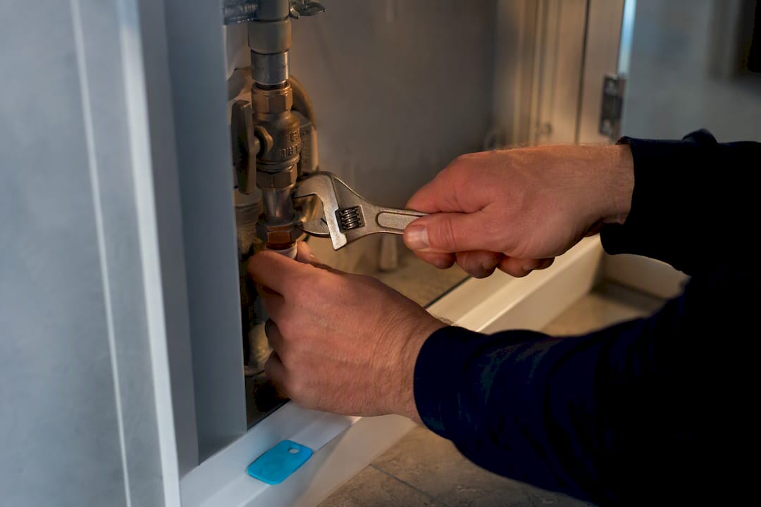 Plumber inspecting an anonymous valve joint