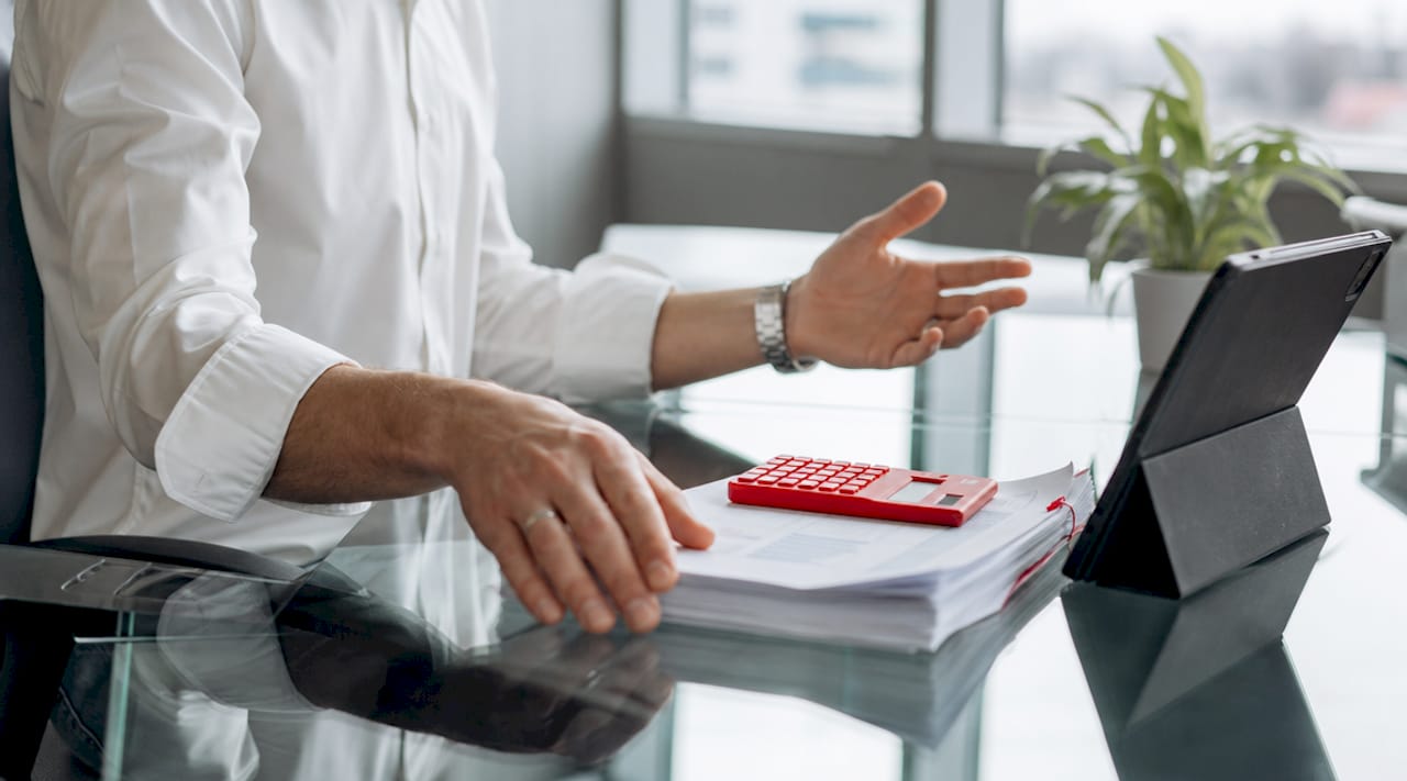 Hands calculating bulk drug testing costs