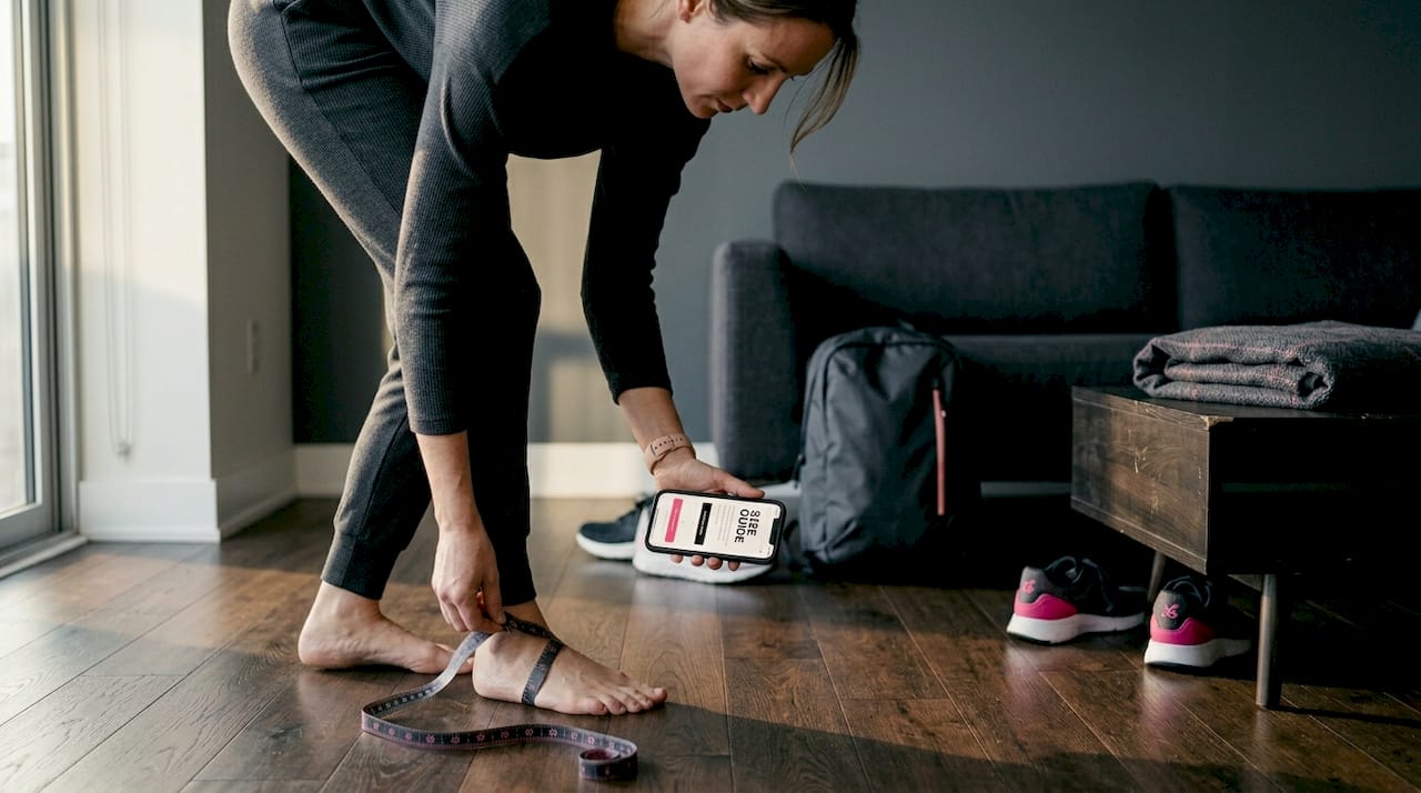 Woman measuring foot for luxury slide fit