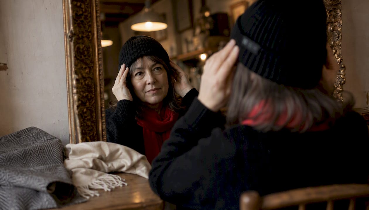 Woman fitting beanie by face and hair type