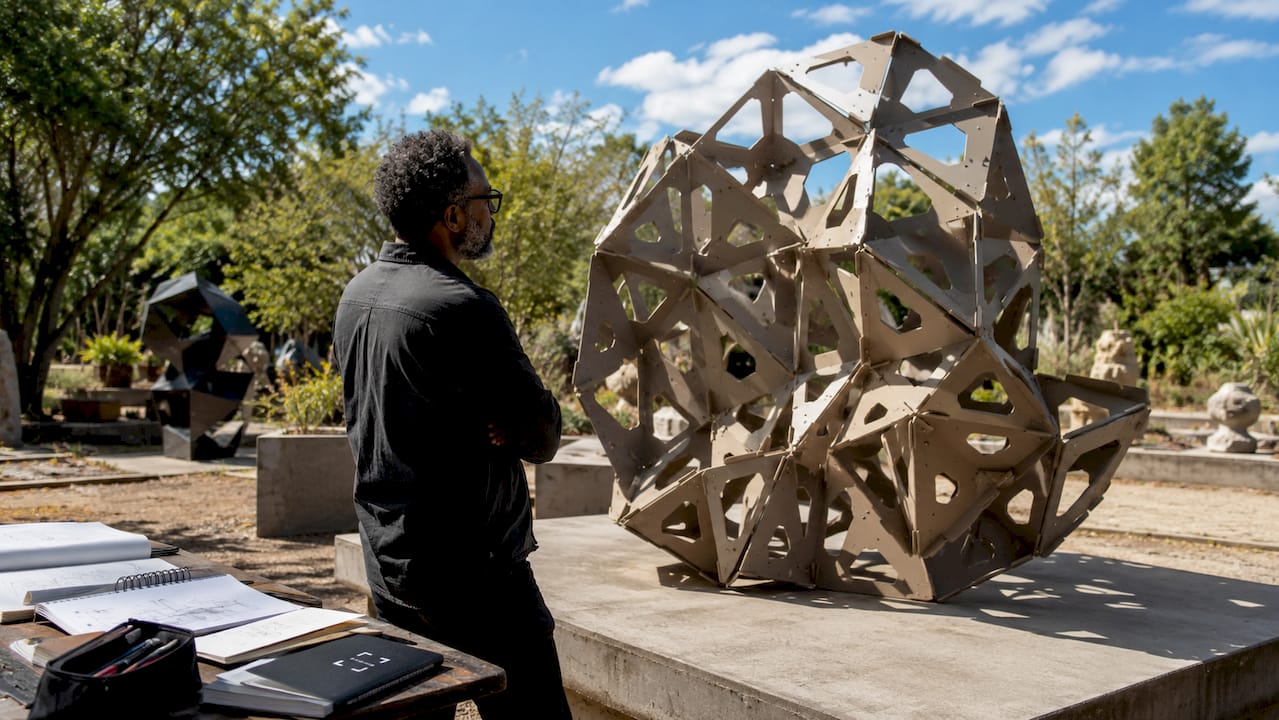 Designer evaluating modular art sculpture