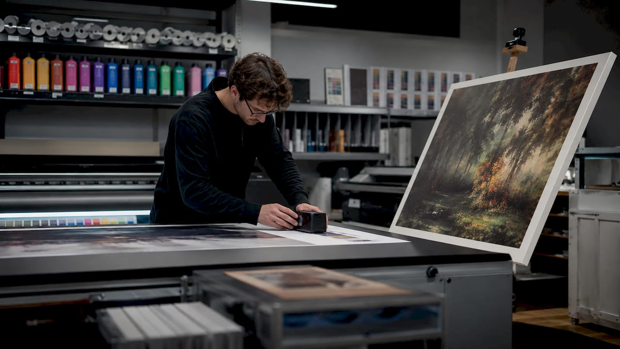 Hands calibrating color on museum-grade print
