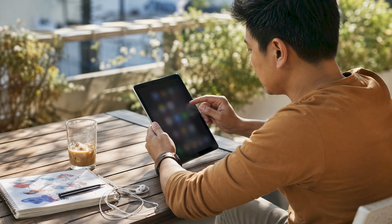 Hands scrolling monetization methods on tablet