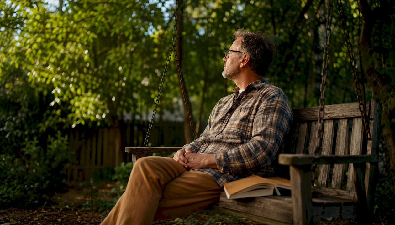 Man reflecting during burnout recovery outdoors
