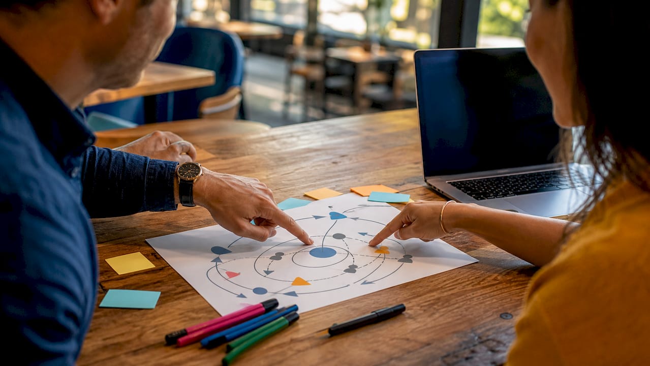 Hands pointing at conflict pattern chart on table