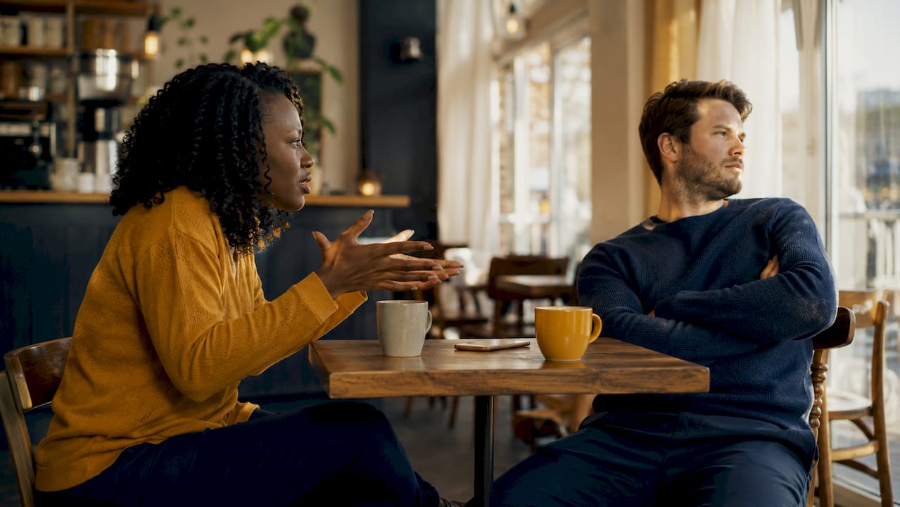 Couple demonstrating demand-withdraw conflict pattern at table