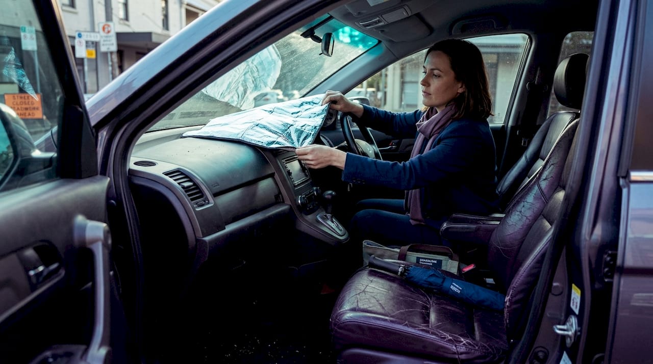 Passenger adjusts sunshade on worn car seat