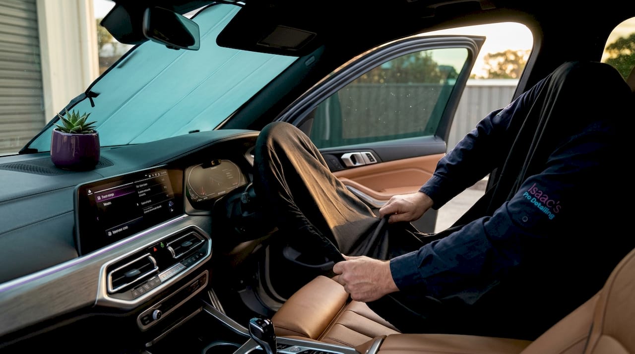 Installing protective seat cover over leather seat
