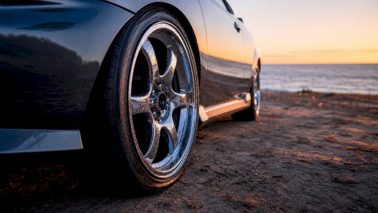 Close-up of water beading on coated car wheel