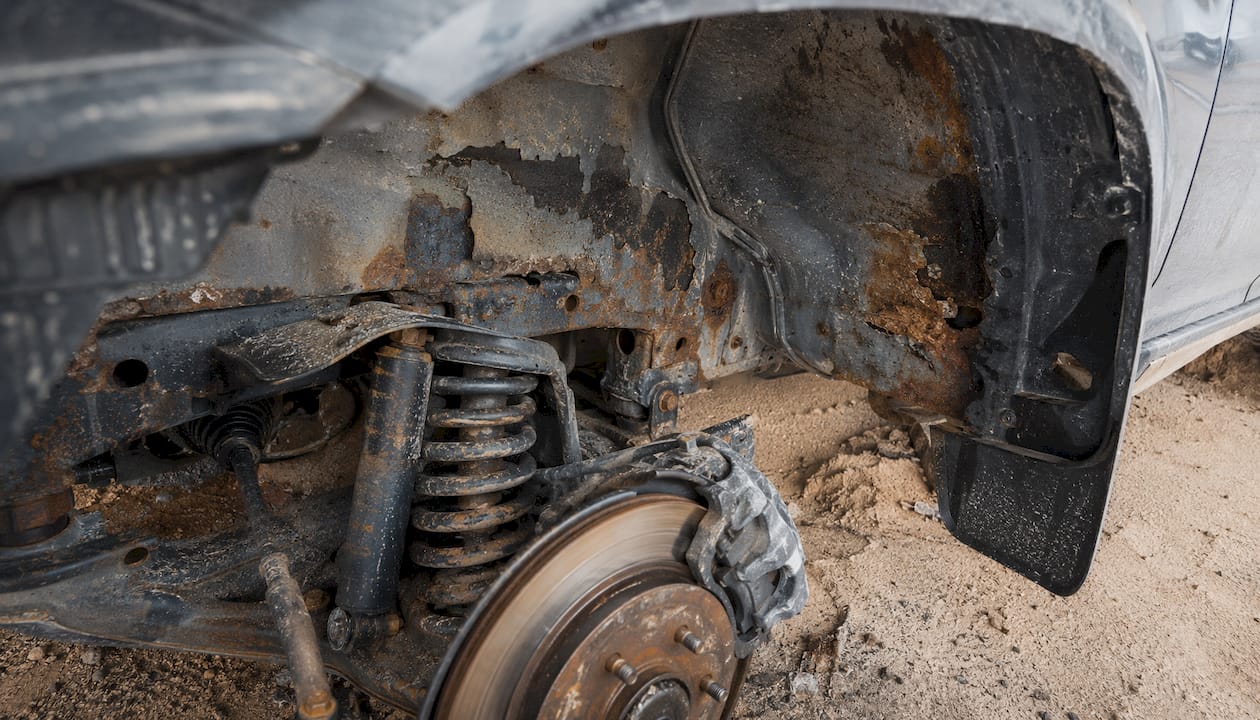 Rust and salt damage under car wheel well