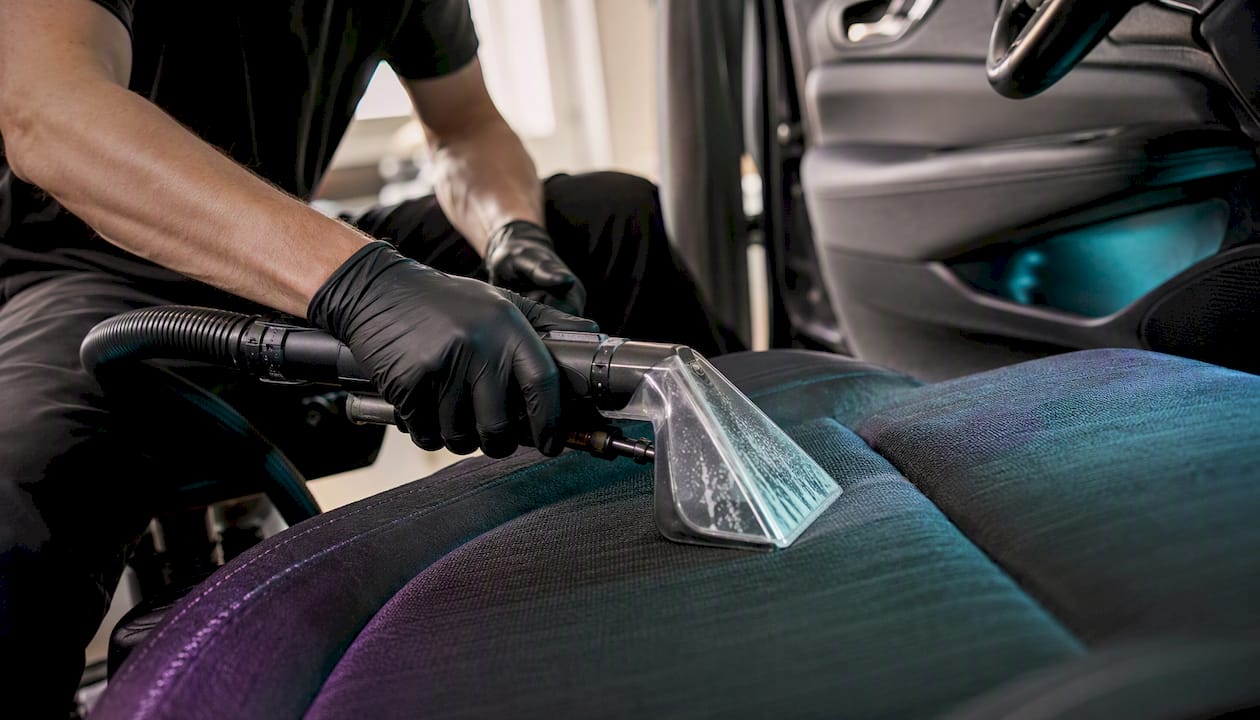 Close-up of machine deep cleaning car seat fabric