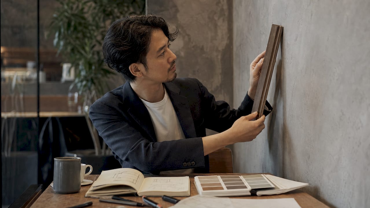 Designer holding wooden trim profile sample