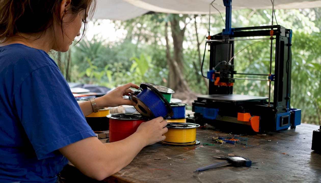 Hands sorting various FDM printer filament spools