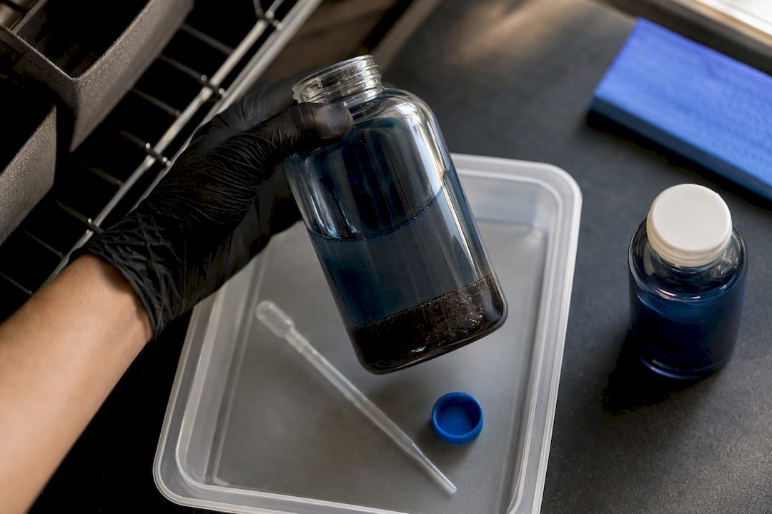 Sublimation ink bottle showing settled sediment