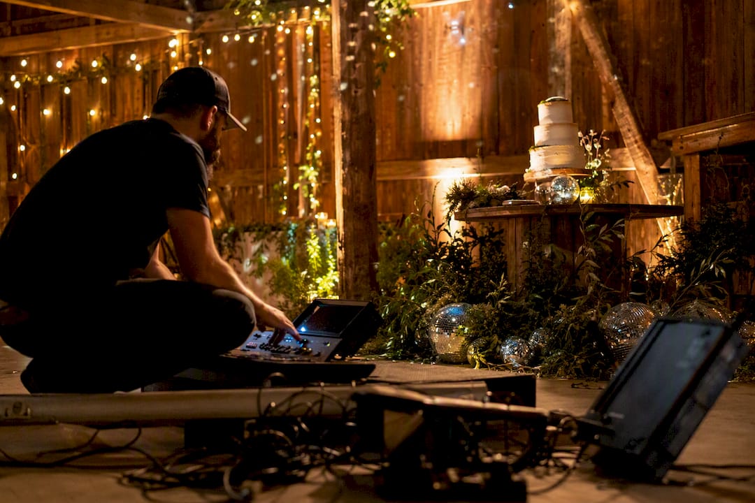 Lighting designer adjusting pin lights in barn venue