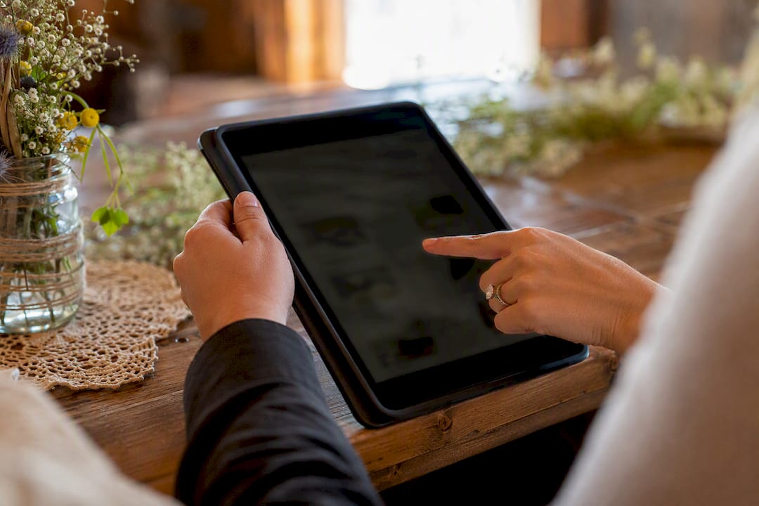 Hands selecting meal choices on tablet invitation