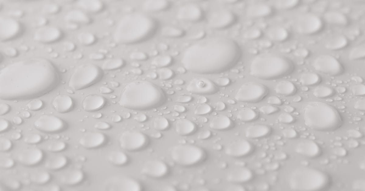 Homeowner inspects water heater with leak and warning poster