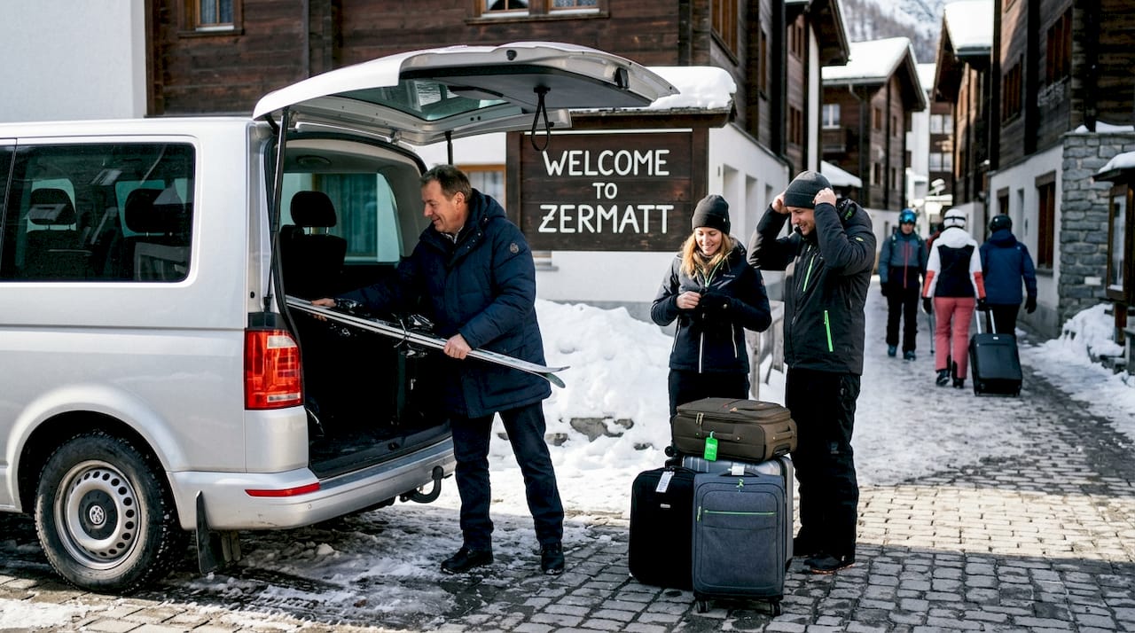 Driver helping travelers at car-free Alpine village