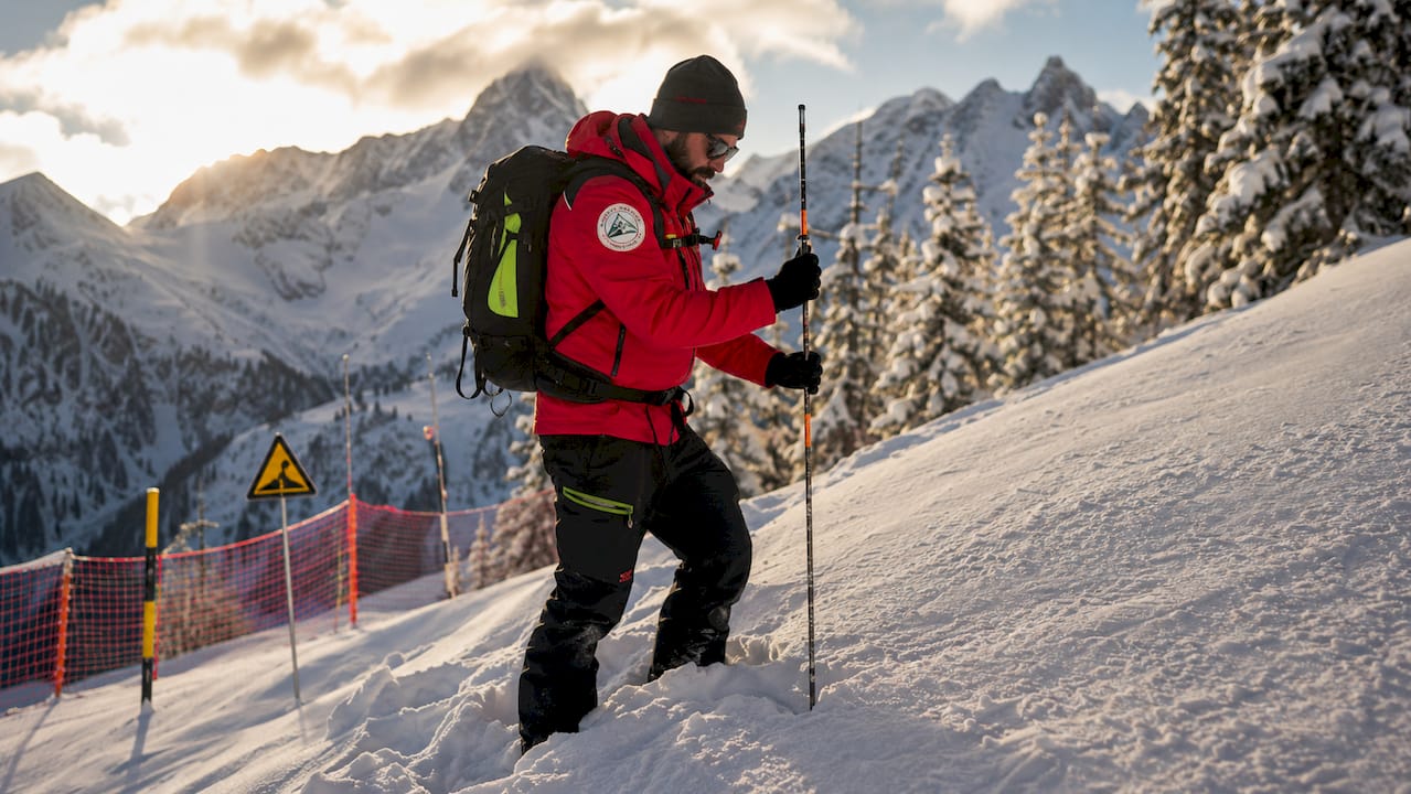 Avalanche safety inspection on snowy Alps slope