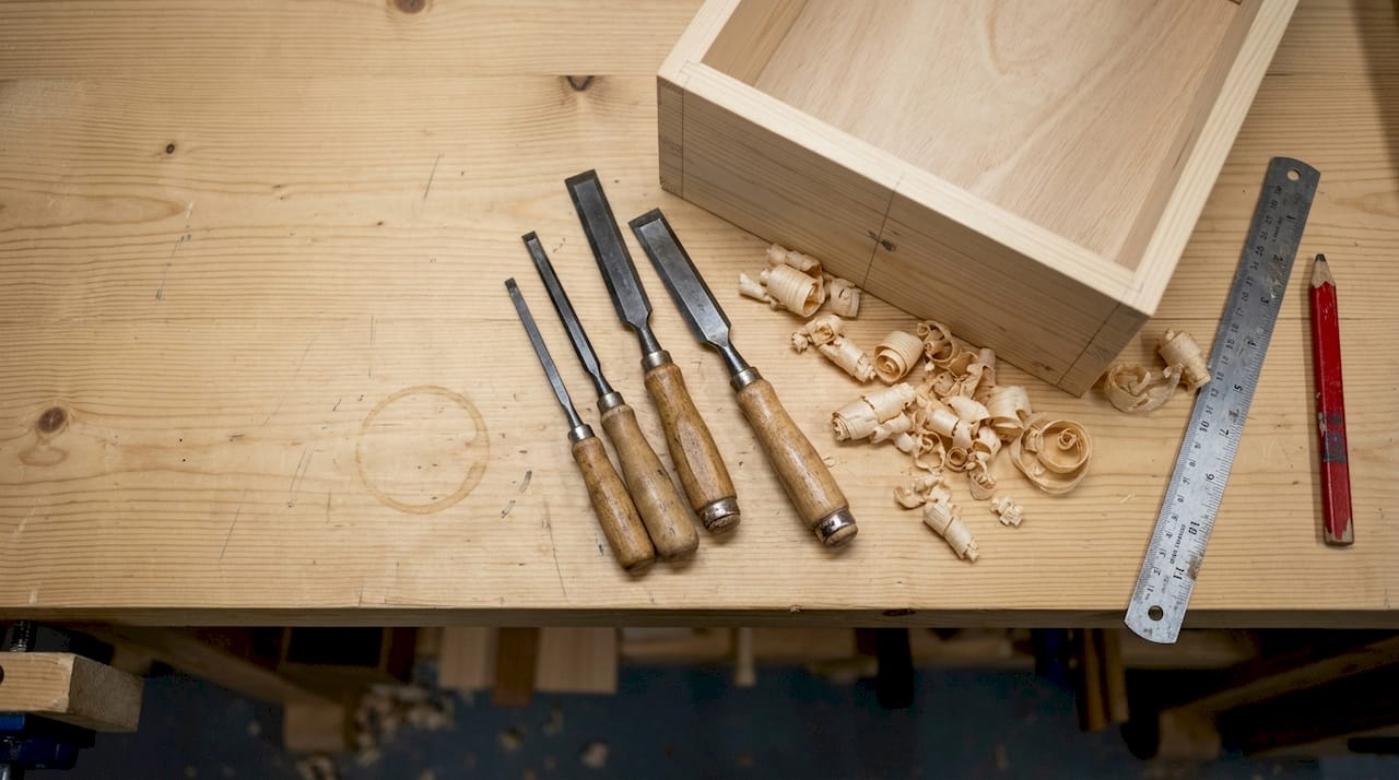Bench chisels on woodworker's worn workbench