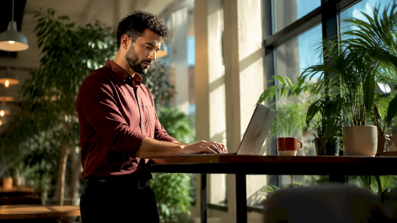 Marketer working on bid ads at desk