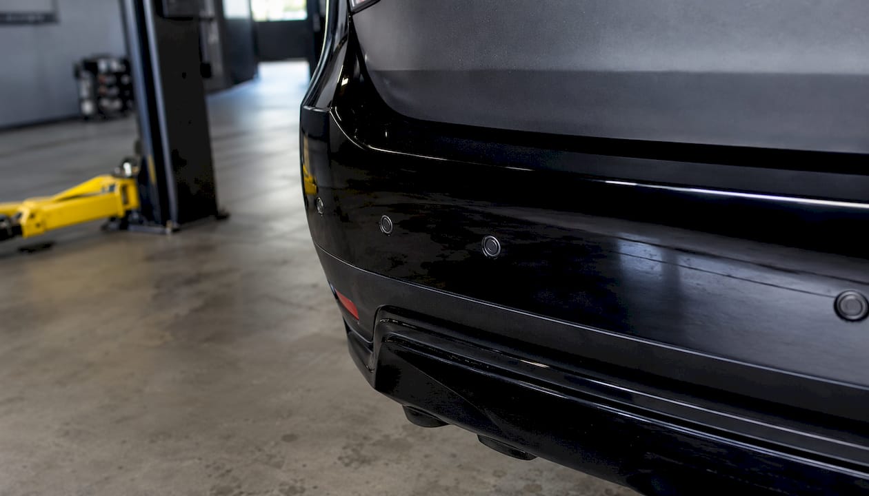 Close-up of four ultrasonic parking sensors on car bumper