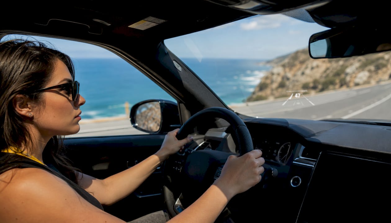 Woman driving SUV using safety features