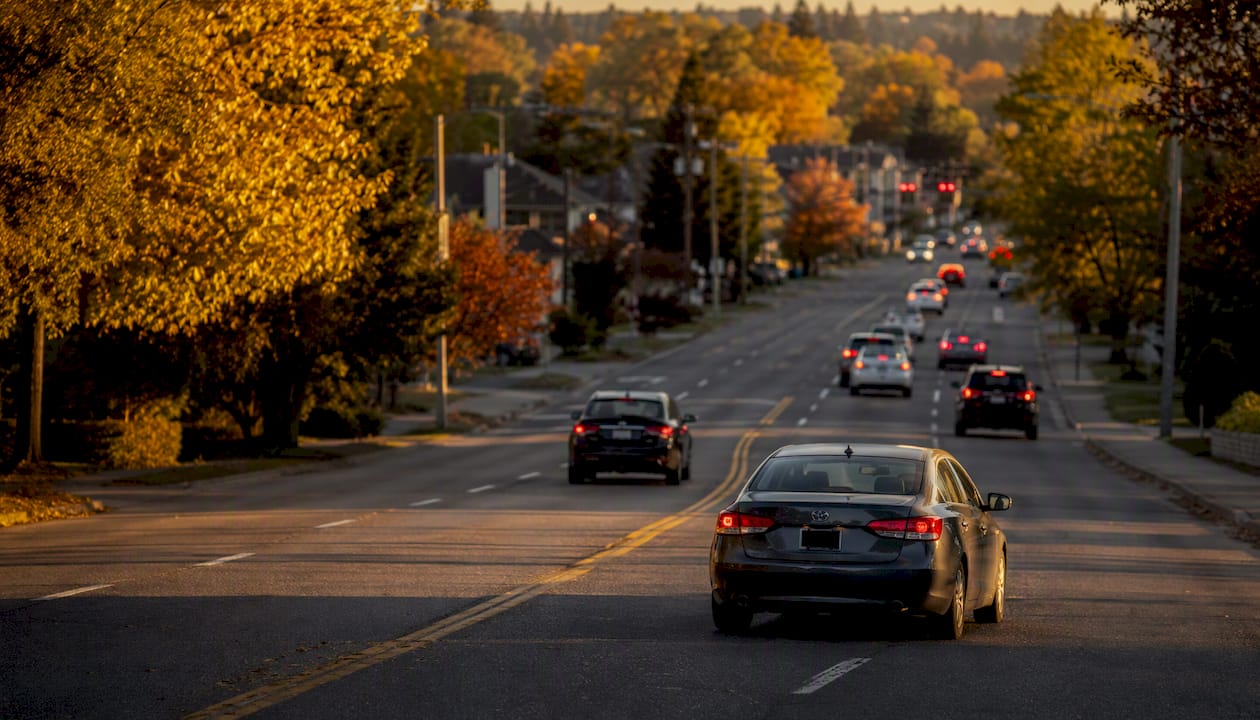 Car driving on suburban street during morning commute