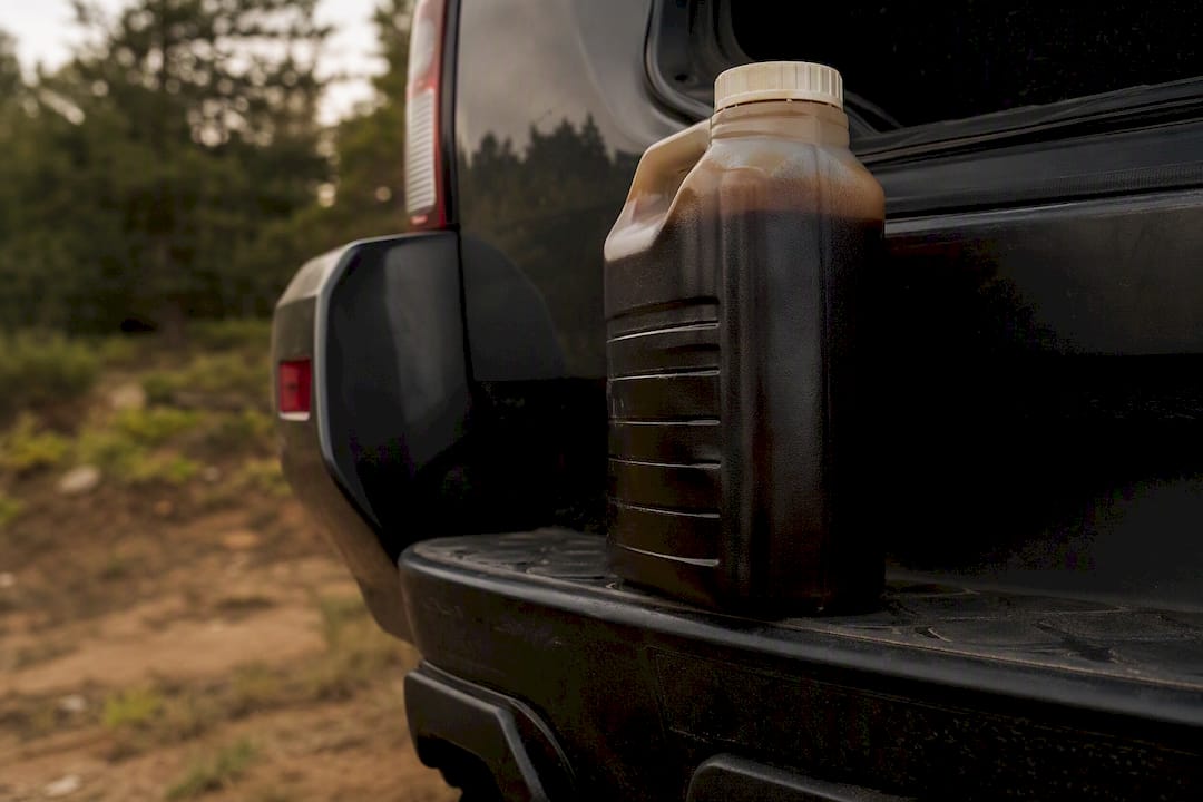 Sealed container with used transmission fluid in truck bed