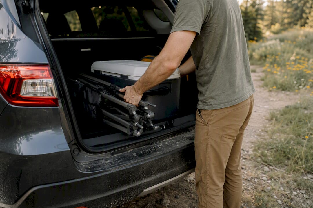 Loading hiking gear into compact SUV rear cargo