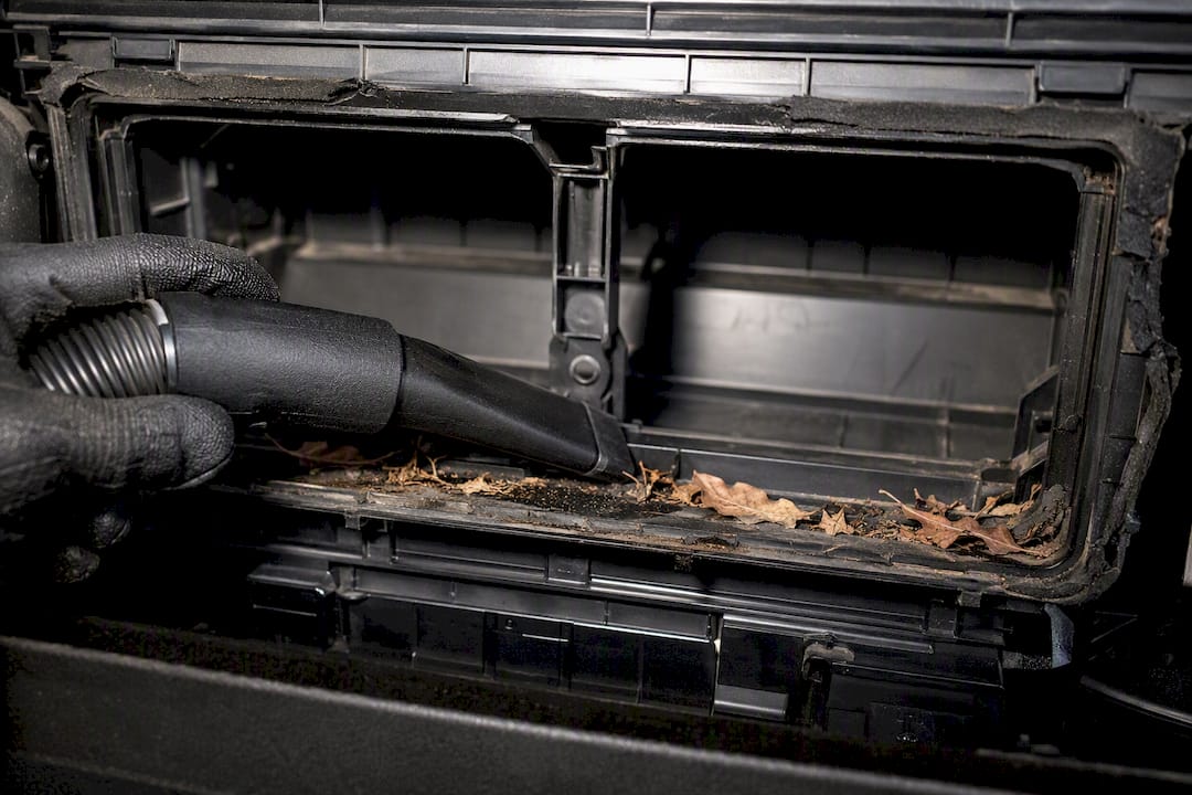 Cleaning debris from cabin filter housing