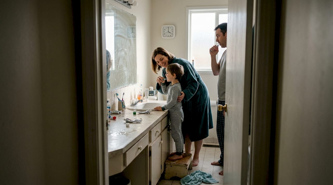Family brushing teeth together in morning
