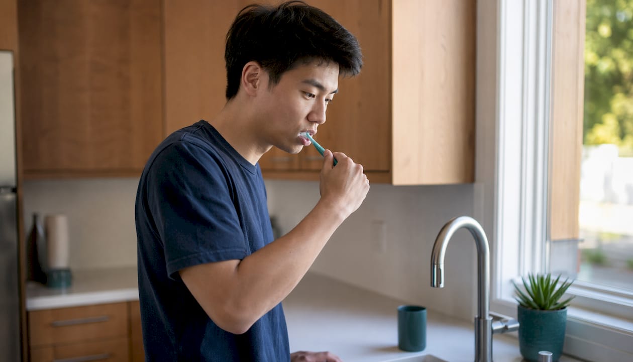 Man practicing proper tooth brushing technique