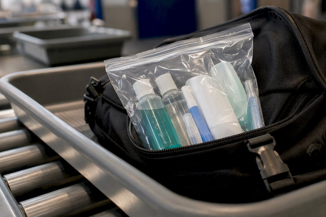 TSA security bag with toiletry items and toothbrush edge