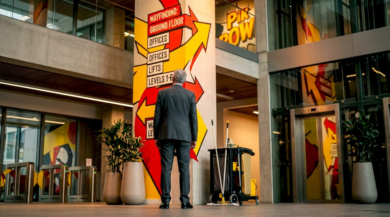 Man checking lobby wayfinding signage
