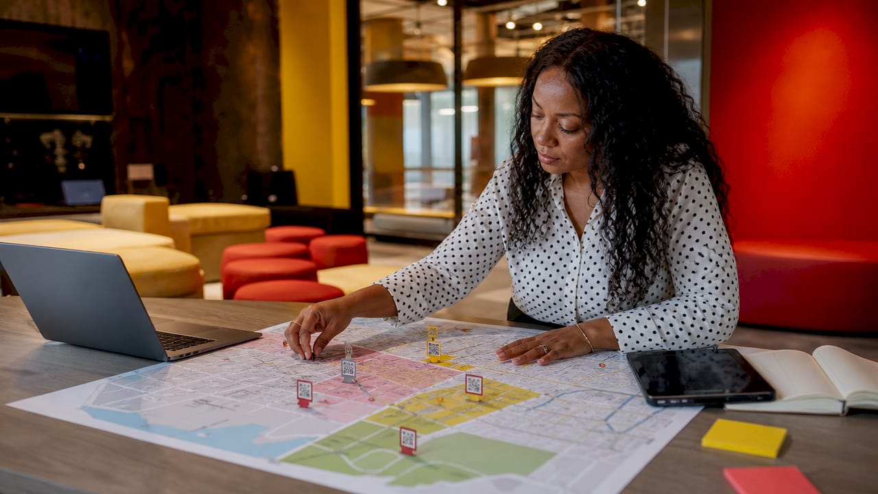 Manager pointing at GIS signage asset map