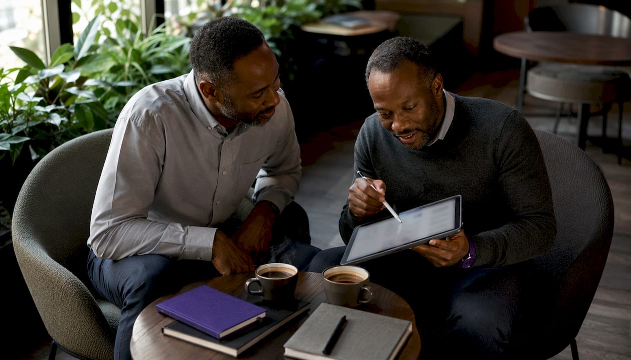 Colleagues comparing finance software side-by-side