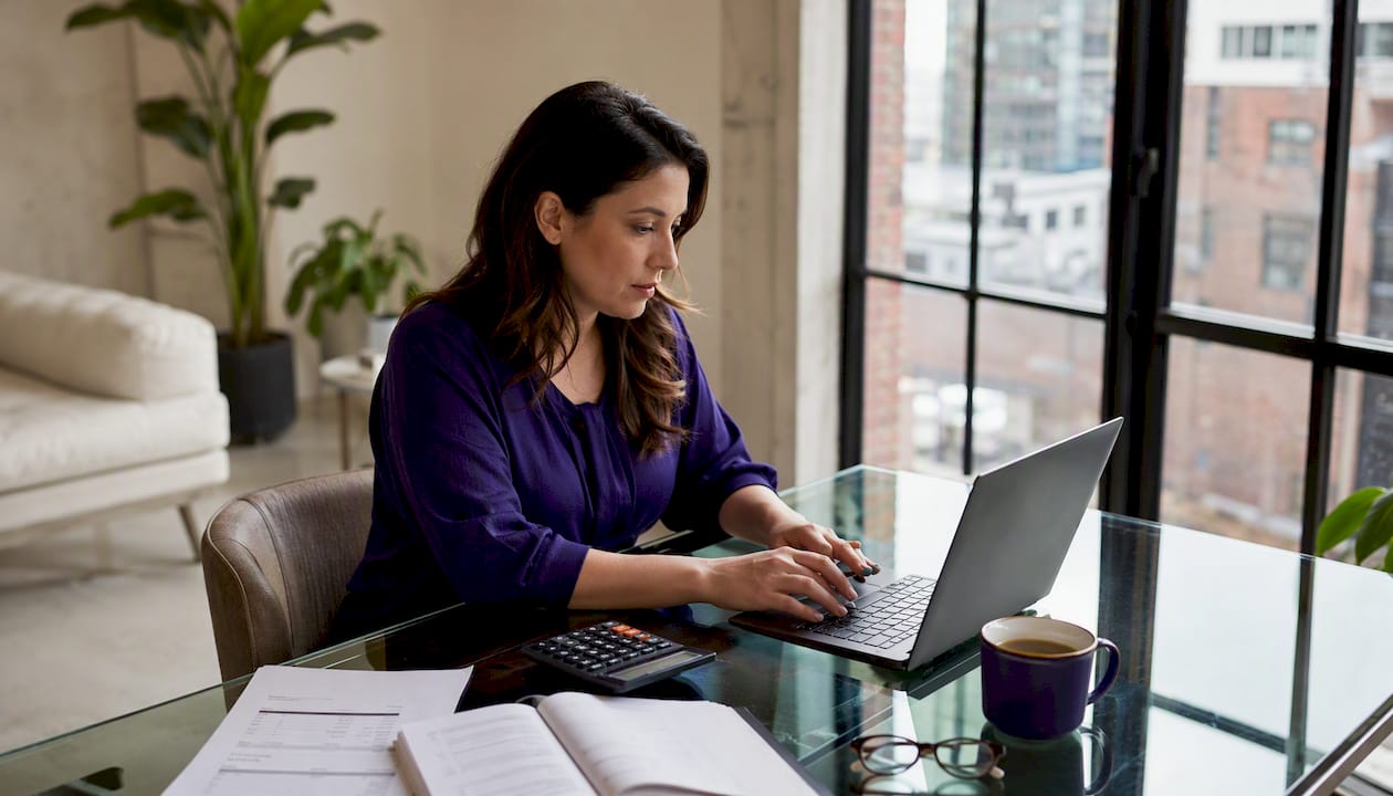 Woman automating bookkeeping at home desk