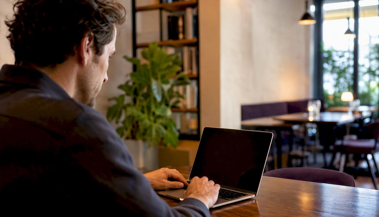 Hands attaching PDF invoice to email draft