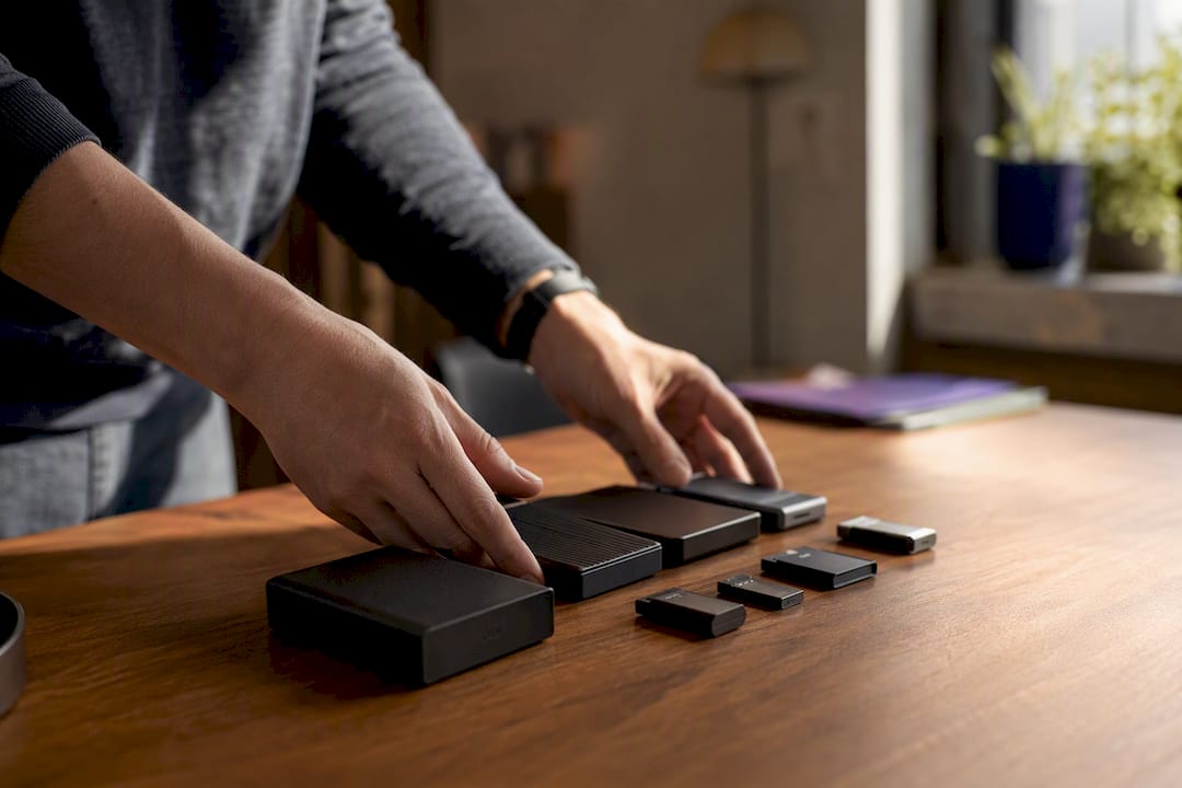 Hands organizing digital storage devices