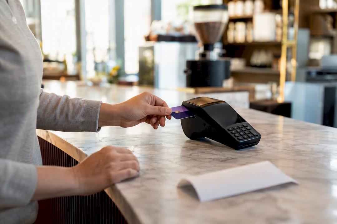 Hands using corporate card in card reader