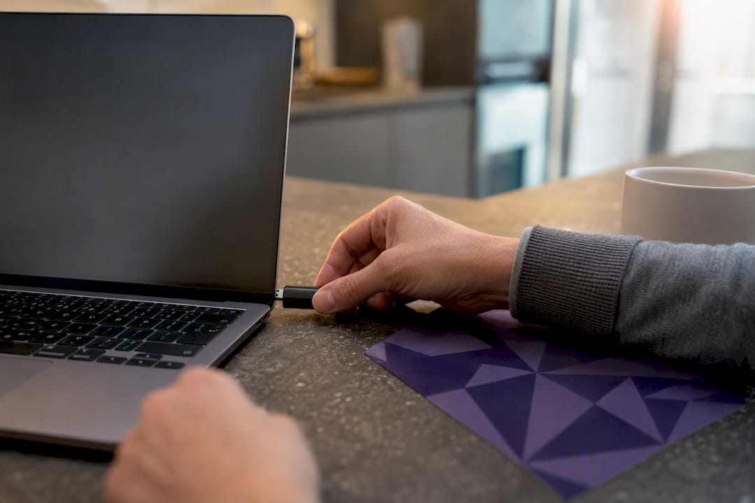 Hand plugging security token into laptop