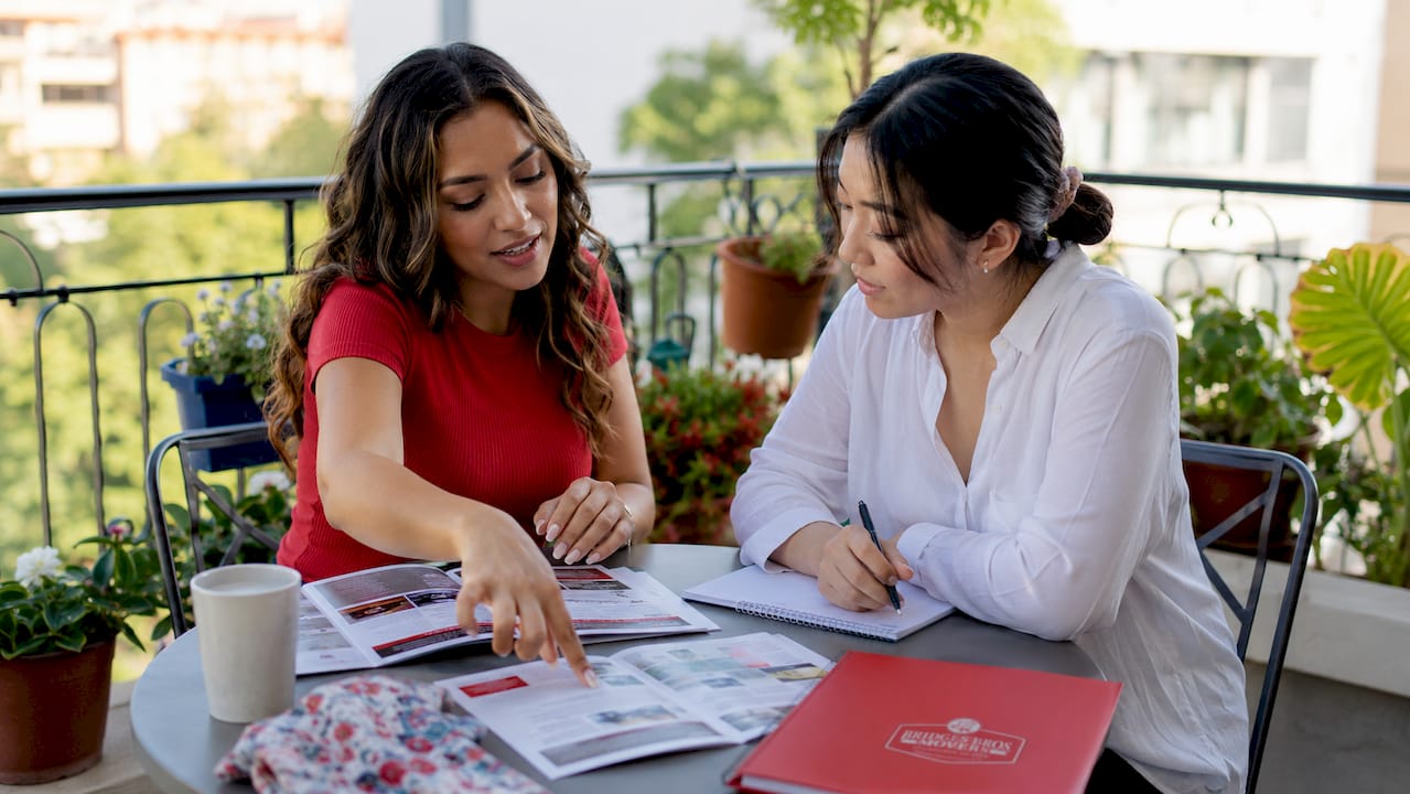 Two women discussing moving financing plans