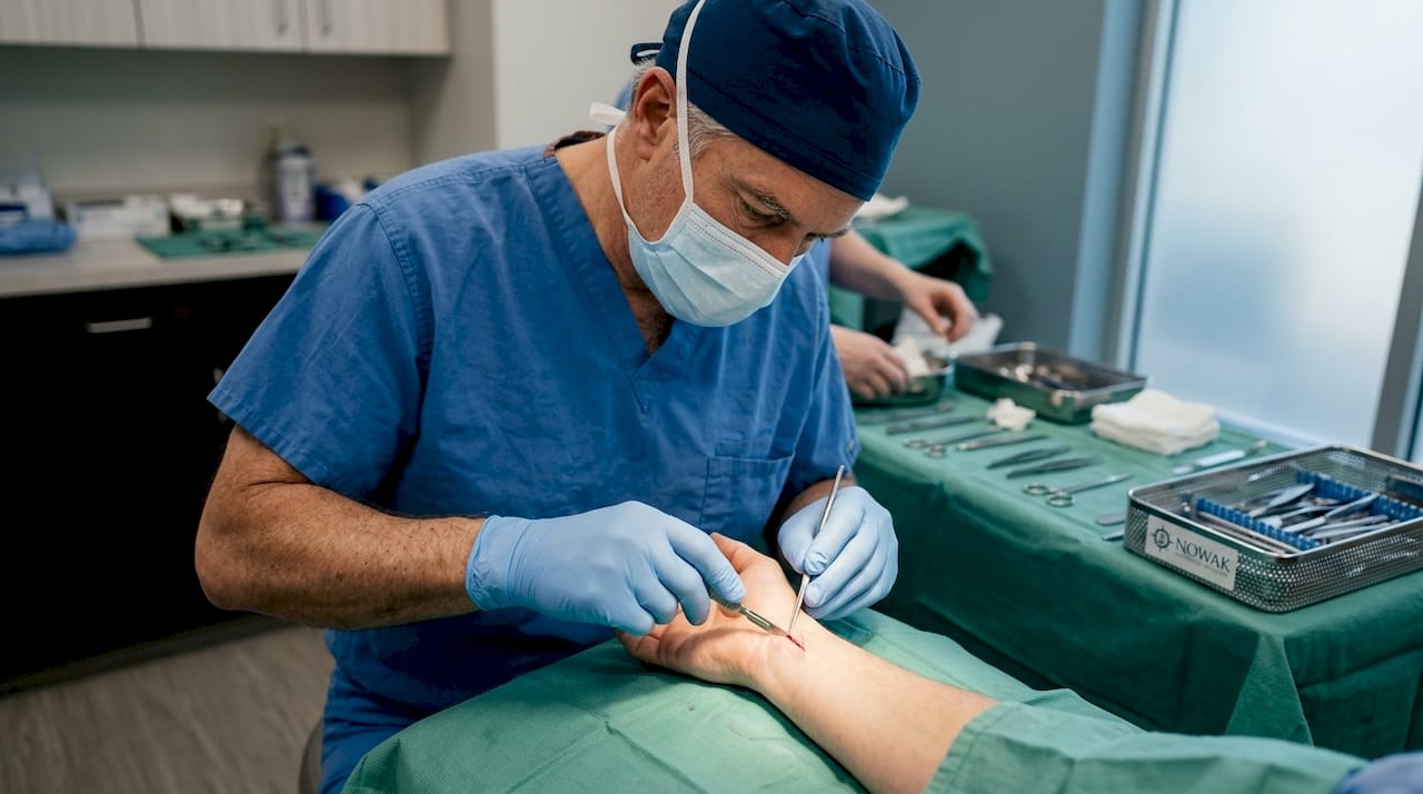 Surgeon's hands performing wrist surgery